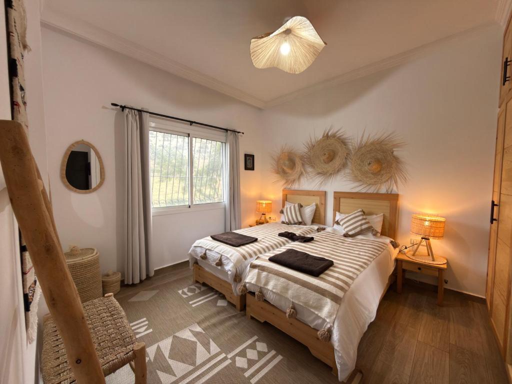 a bedroom with a large bed and a window at Beldi Chic vue Mer - Taghazout in Agadir nʼ Aït Sa