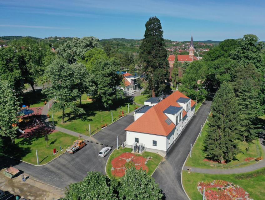 an aerial view of a small white building with a red roof at Hostel i Restoran SEQUOIA in Slatina