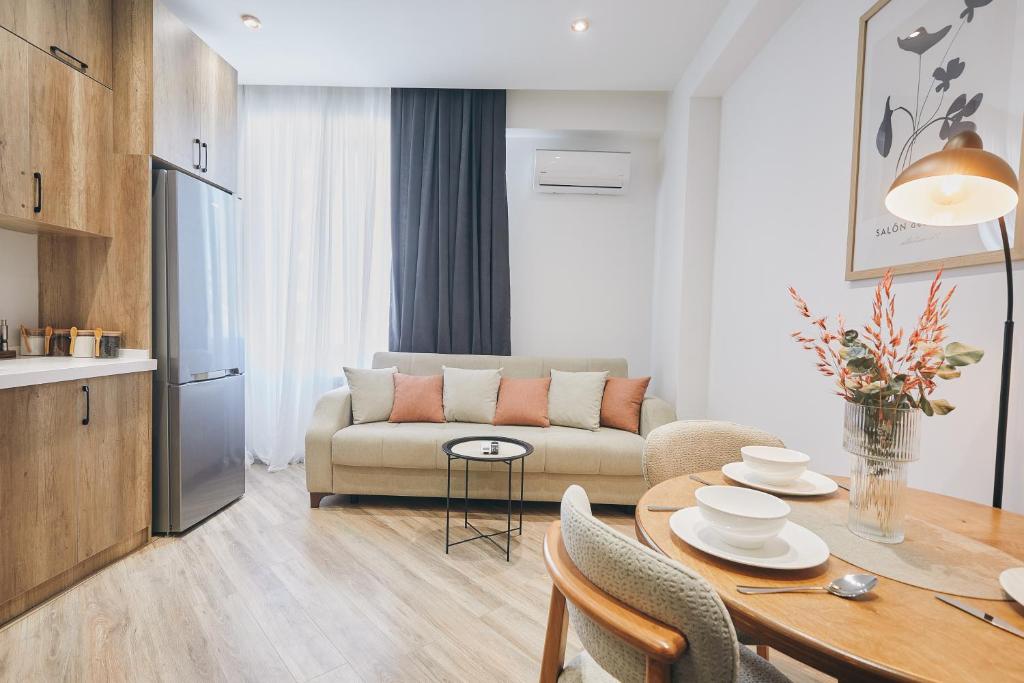 a living room with a couch and a table at Avant Park GK Aparts in Baku