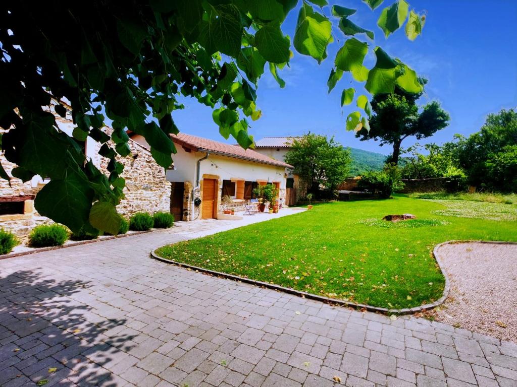 a house with a yard with a brick driveway at EVASION NATURE ET CONVIVIALITÉ in Sourcieux-les-Mines