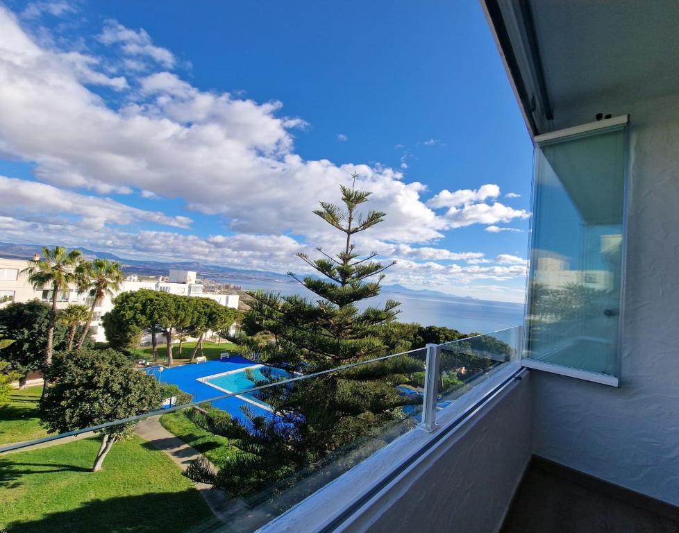 a balcony with a view of a swimming pool and the ocean at Sea and Mountains in Gran Alacant