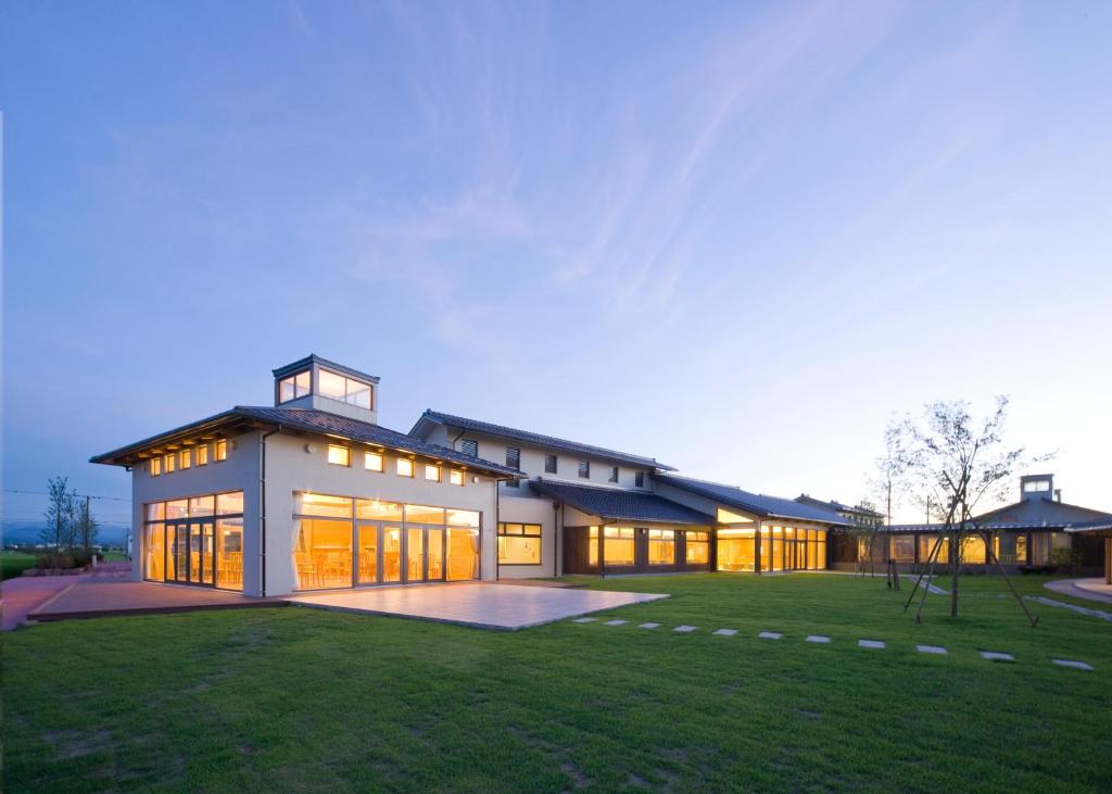 a large house with a lot of windows at ウェルネスハウスさらい in Nomi