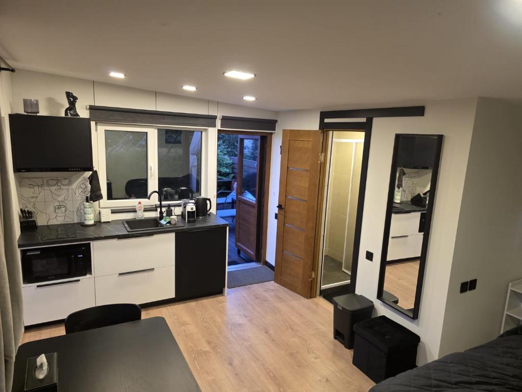 a kitchen with a sink and a counter top at Tīkli 3 in Bigauņciems