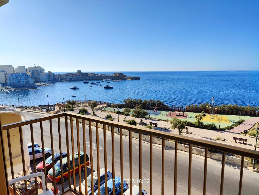 a view of the ocean from a balcony at Seafront 3 bed Panoramic SeaViews Apt B7- in Qbajjar