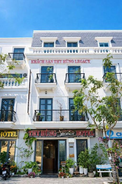 a large white building with signs on it at Thy Hung legacy hotel in Tuy Hoa