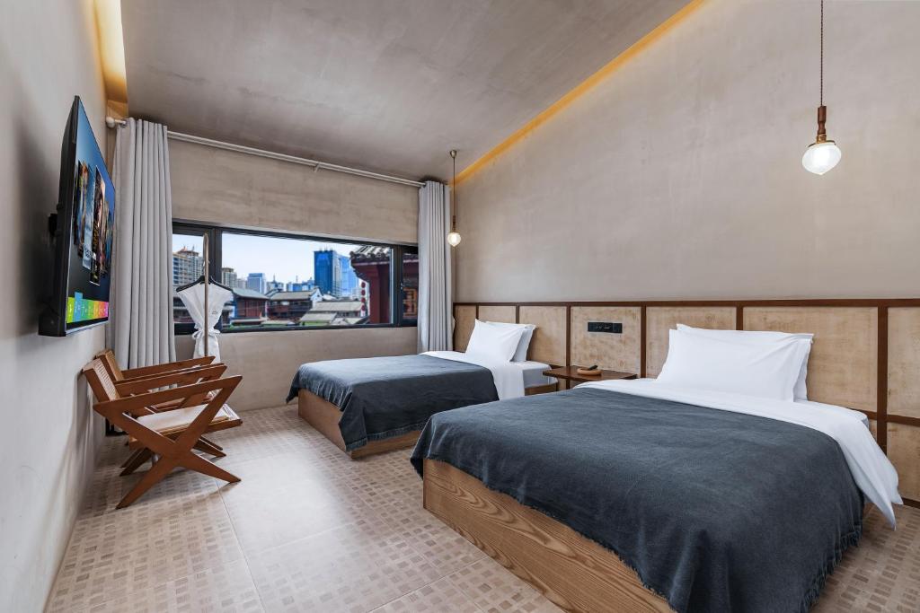 Vuode tai vuoteita majoituspaikassa Kunming Latosol hotel