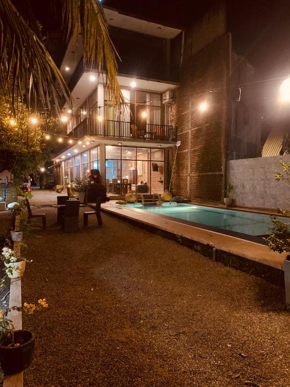 a house with a swimming pool at night at Cielstar Resort in Anuradhapura