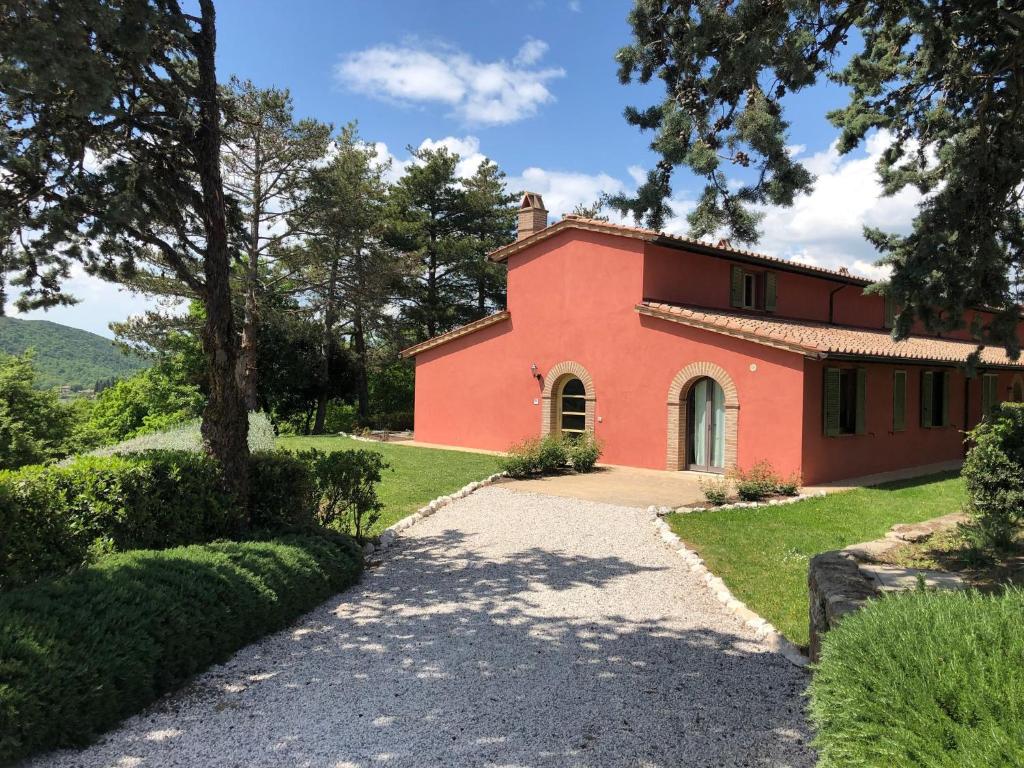 a red house with a tree and a driveway at Villa Cielo- Cignella Resort Tuscany Accommodation in Osteria Delle Noci