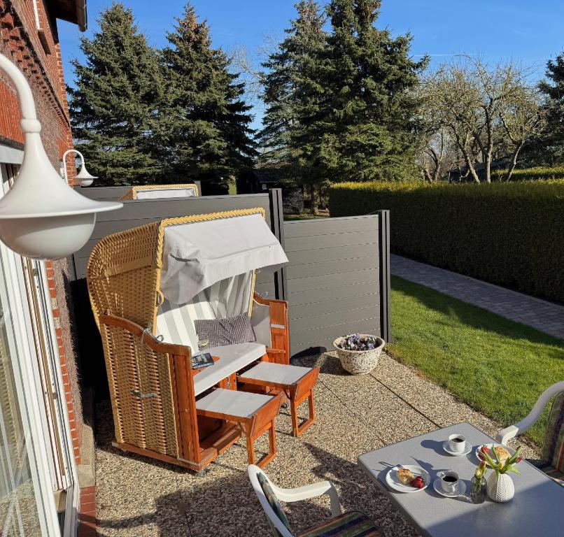 a patio with a table and a chair and a table at Backhuus 2 in Fehmarn
