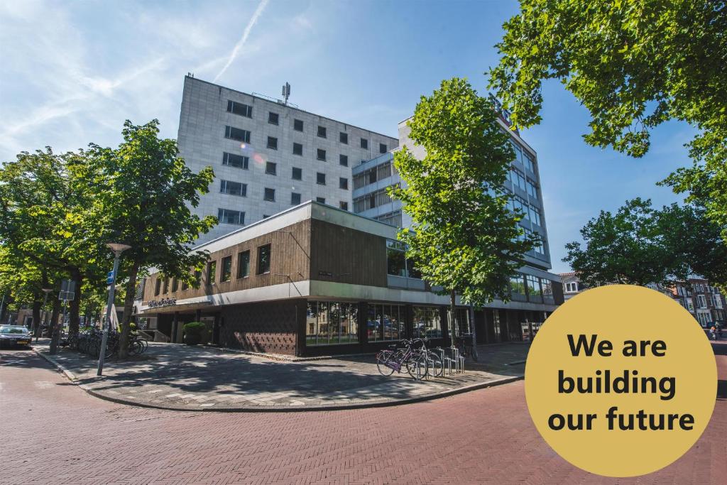 a building with a sign that says we are building our future at Flonk Hotel Groningen Centre, BW Signature Collection in Groningen