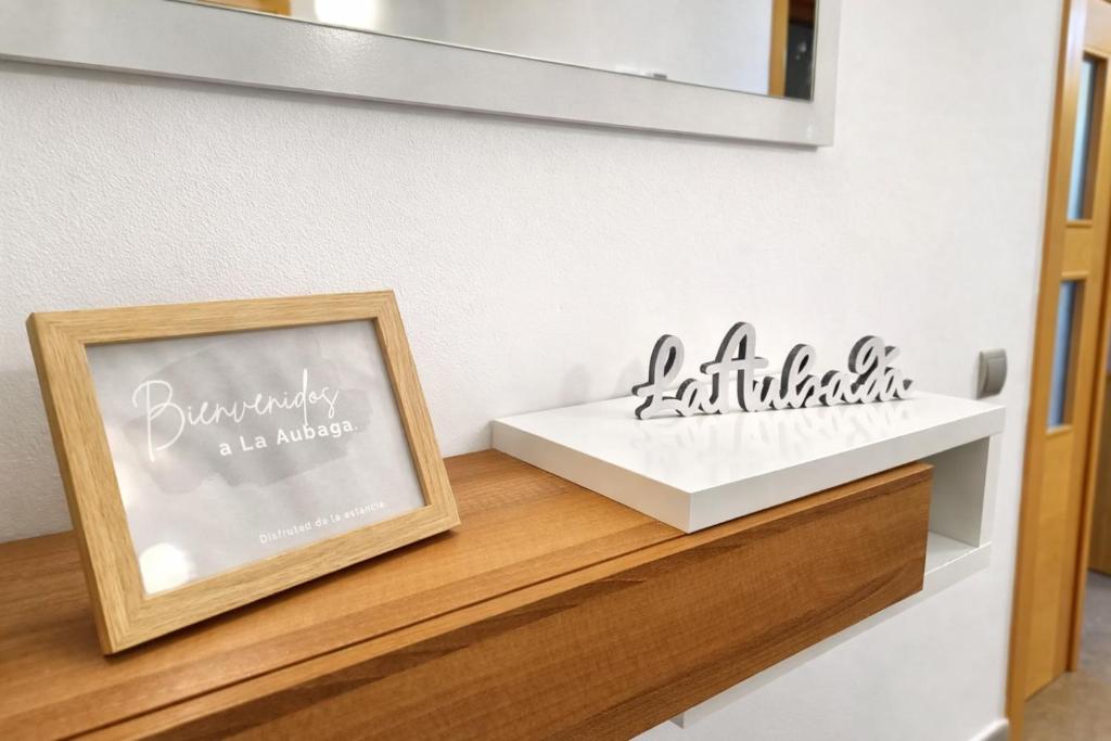 a picture on a shelf with a mirror at Apartamentos La Aubaga in Valderrobres