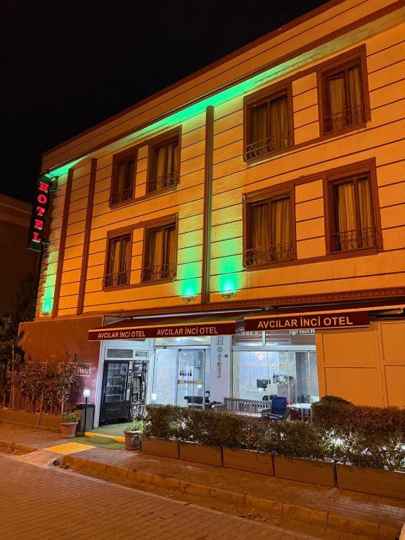 a building with green lights on the side of it at Avcılar İnci Hotel in Istanbul