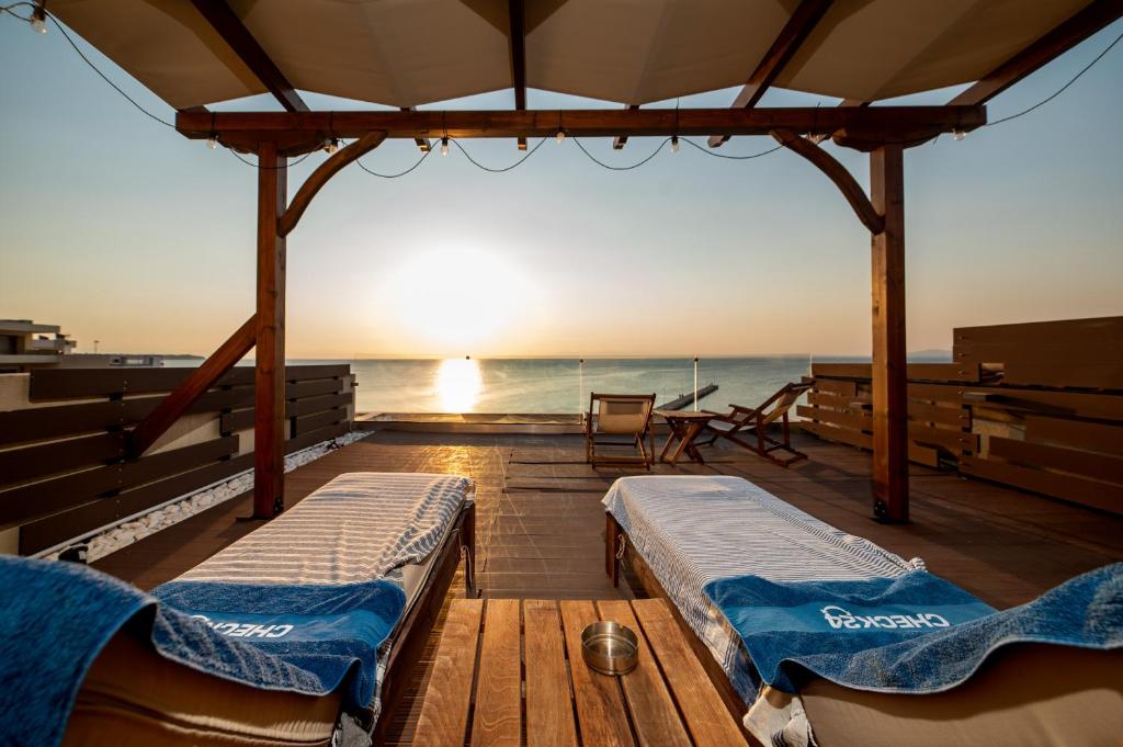 two beds on the deck of a boat at Vento di Mare in Perea