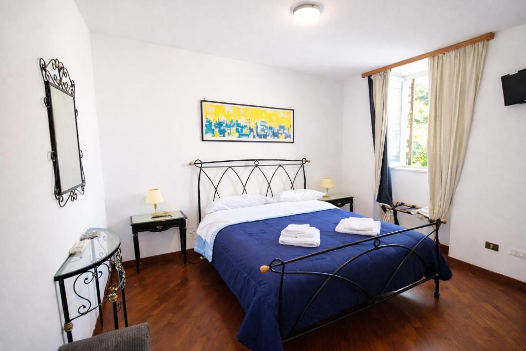 a bedroom with a blue bed and a window at A due passi dal Teatro Massimo in Palermo