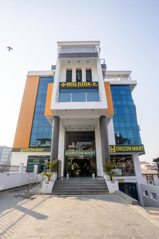 a large building with a staircase in front of it at Hotel Eleven in Kathmandu