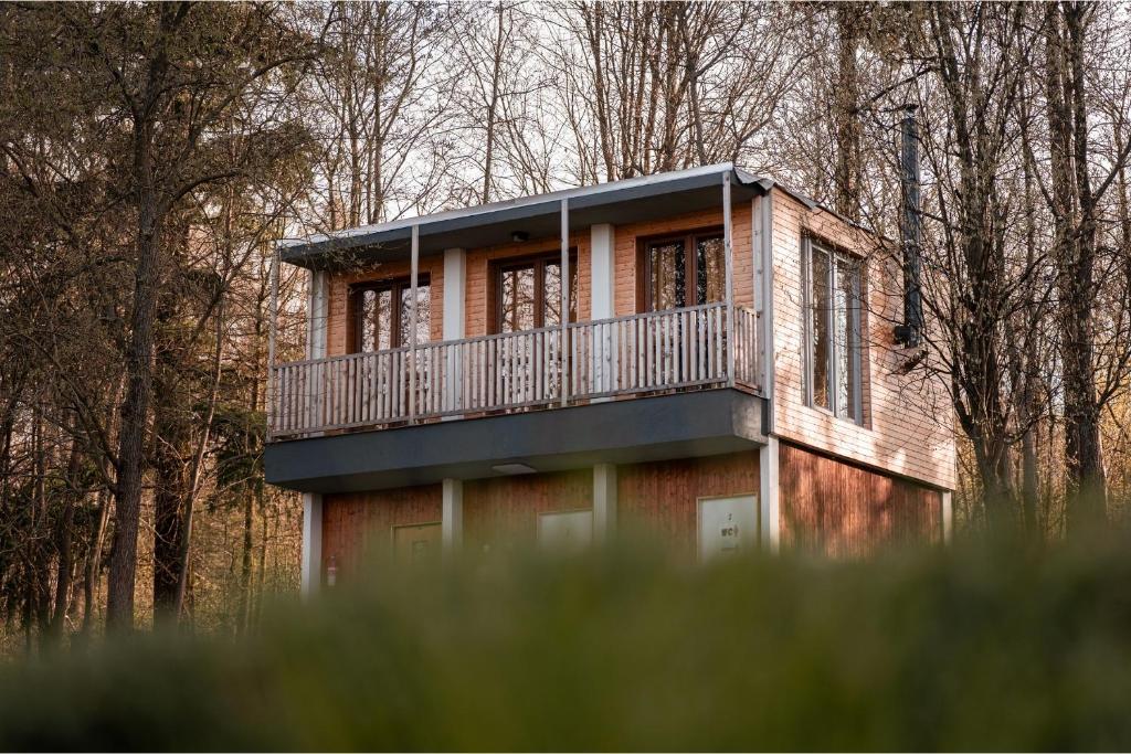 a house with a balcony in the woods at Tiny house v Moravském Berouně in Moravský Beroun