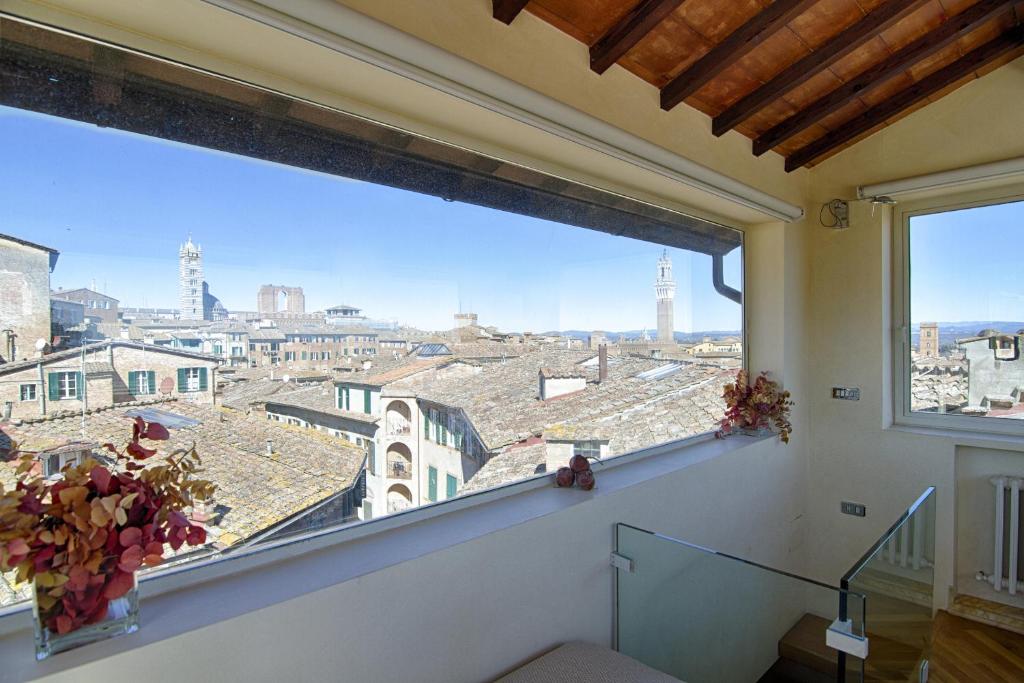a large window in a room with a view of a city at Rinidia Siena Centro in Siena