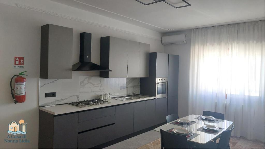 a kitchen with a table and a stove top oven at A Casa di Nonna Lidia in Crotone