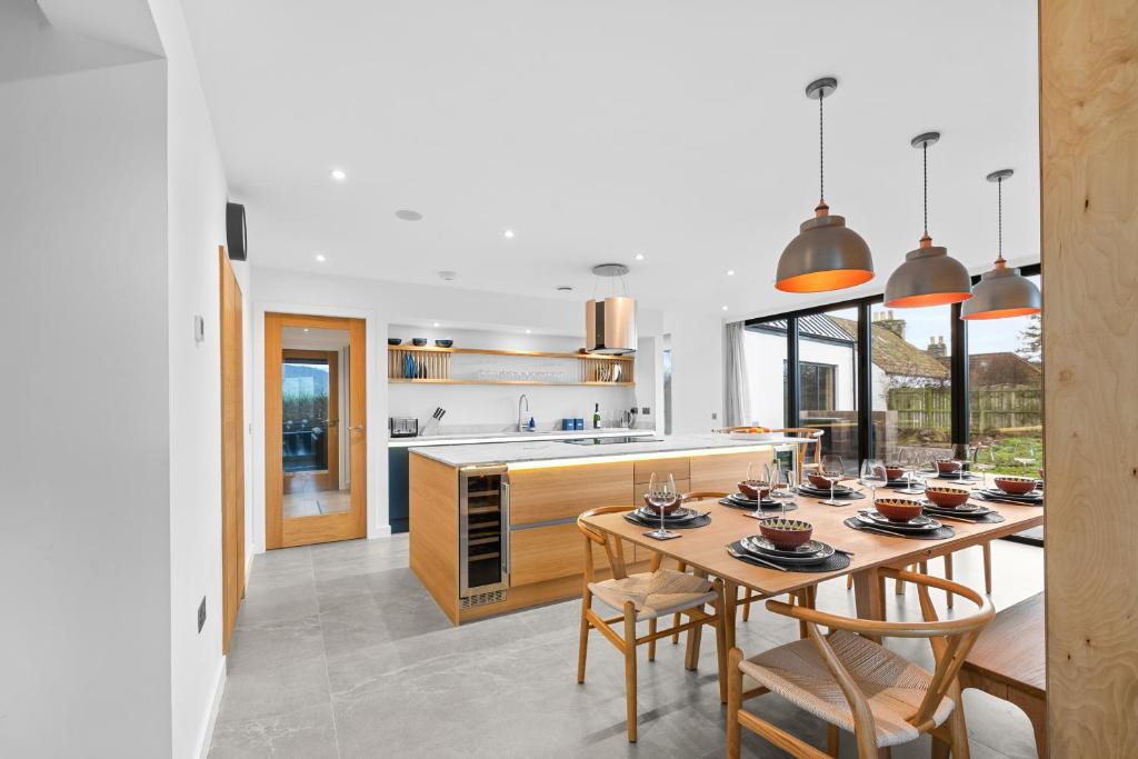 a kitchen with a table and chairs and a kitchen with a counter at An Teallach in Balmullo