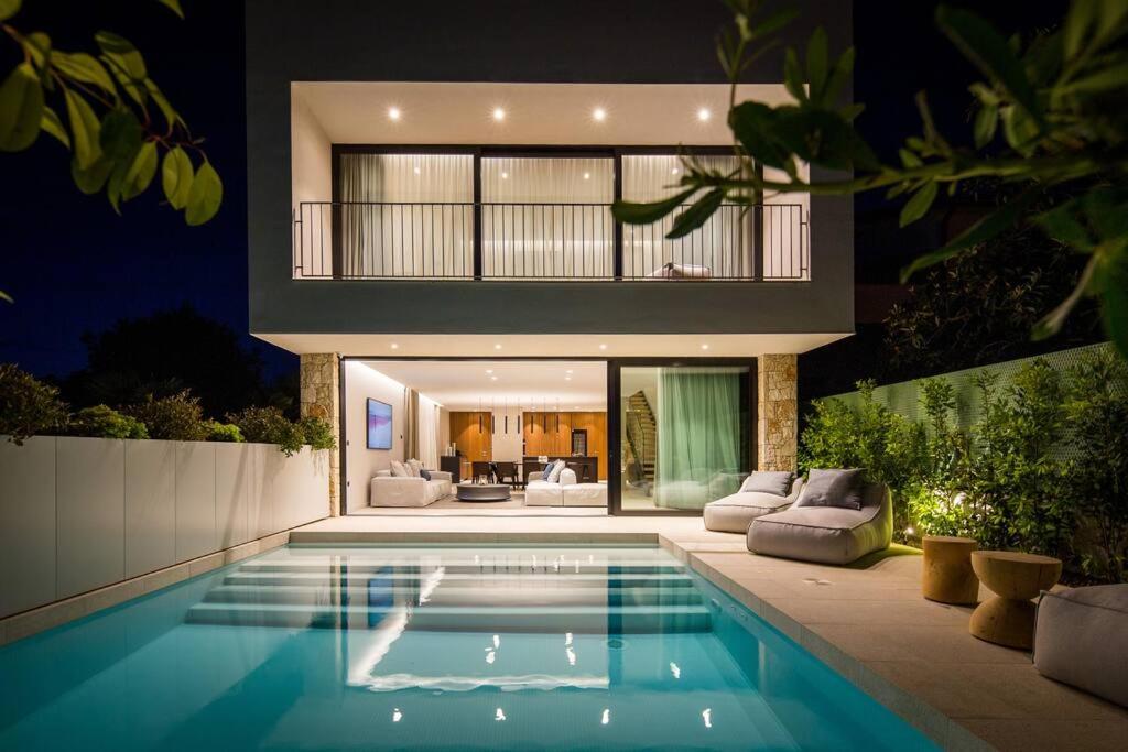 a house with a swimming pool at night at Z6 Dolcevita Signature - Villa & Private Yacht in the Heart of Rovinj in Rovinj