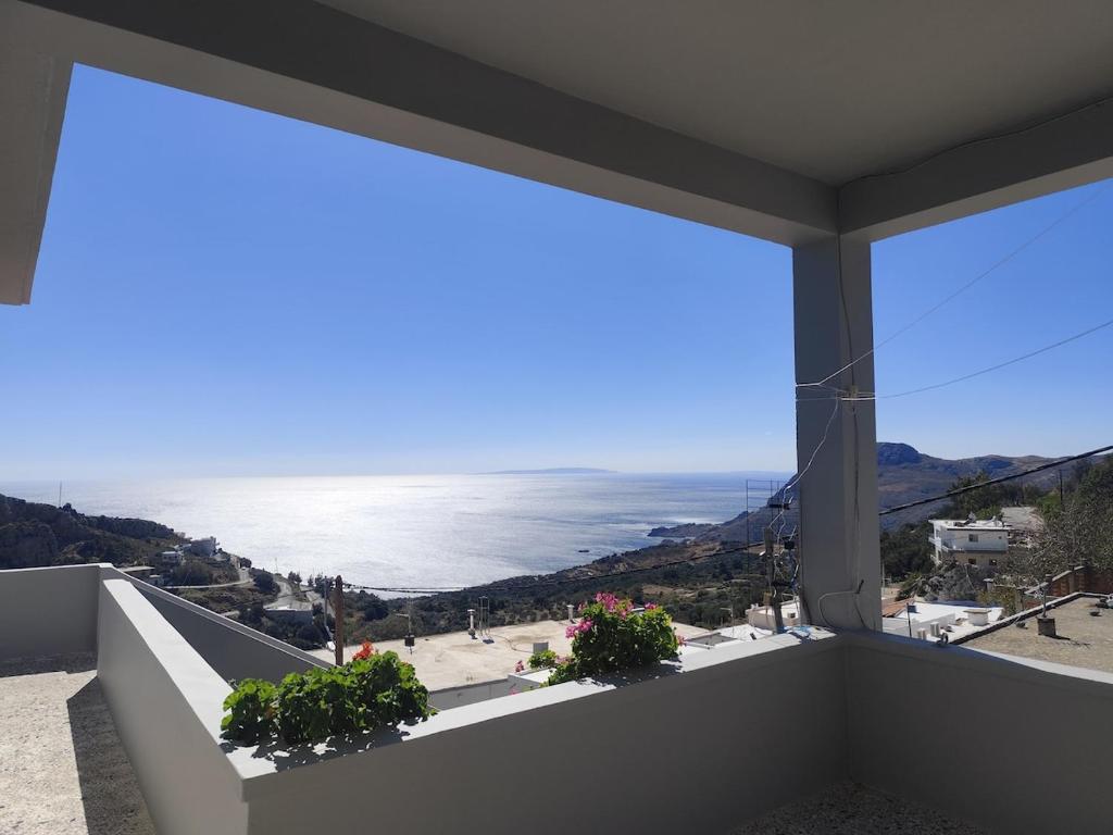 a view of the ocean from a balcony at Panorama Georgia's house in Áyios Vasílios