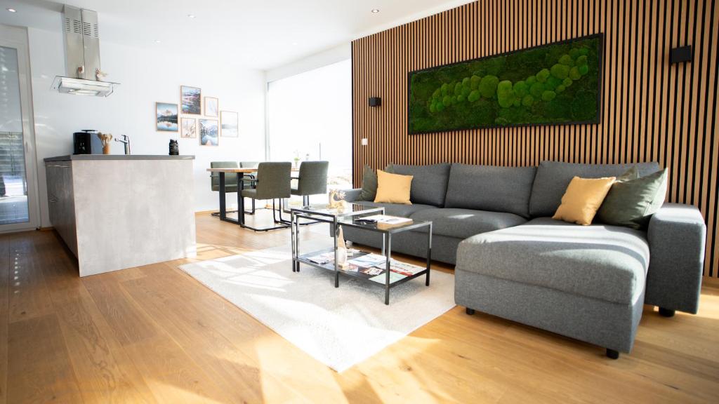 a living room with a couch and a table at Großzügige Gartenwohnung mit Bergblick in Fritzens