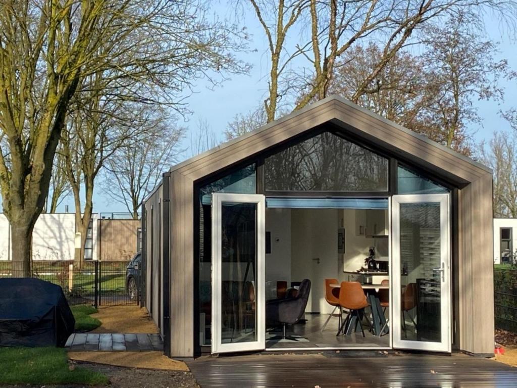 a small house with sliding glass doors at Beachhouse in Hulshorst
