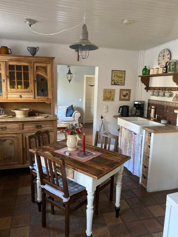 a kitchen with a table and chairs in a room at Stern in Bergheim