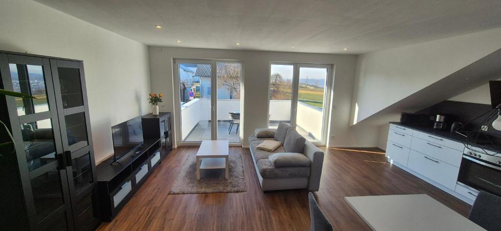 a living room with a couch and a television at Neckartalblick in Nürtingen