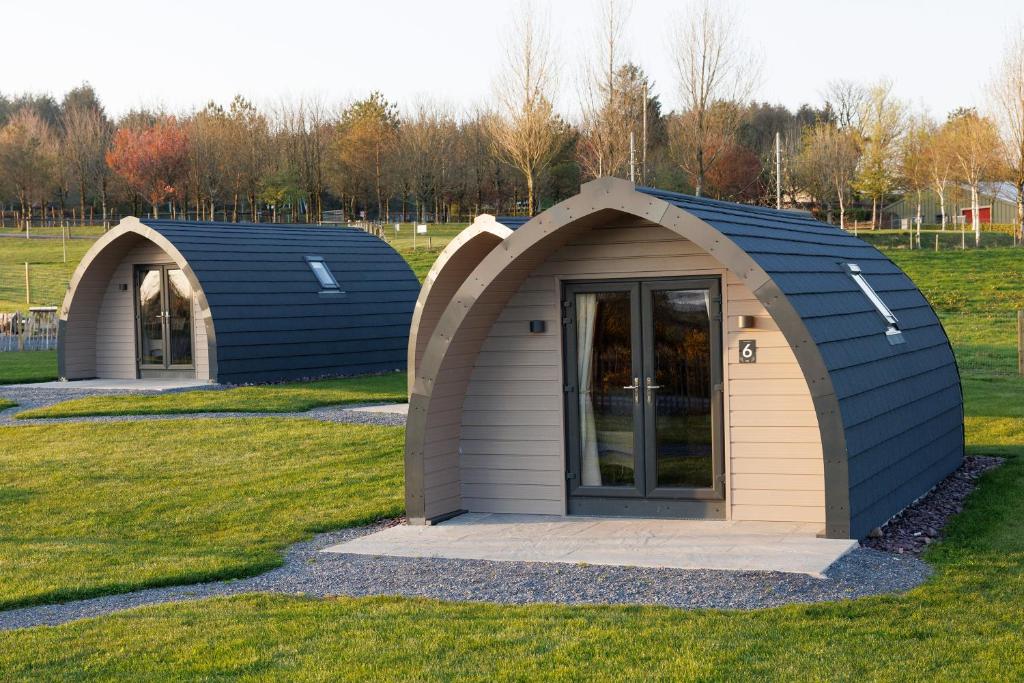 two small storage sheds in a grassy field at Leahys Pod Park in Cork