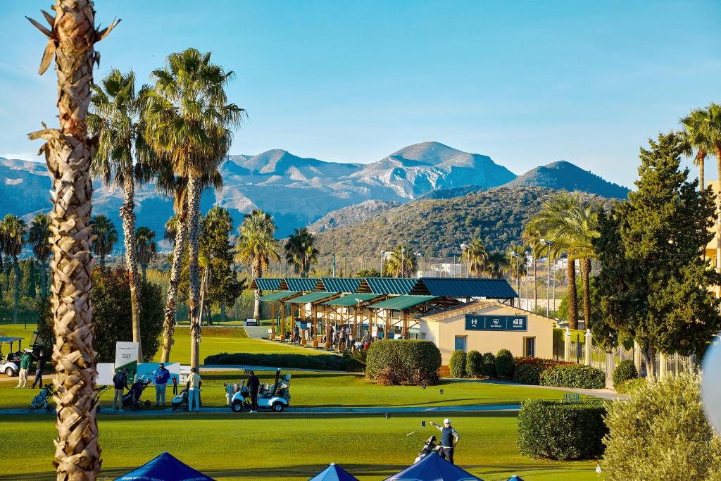 a view of a golf course with mountains in the background at Las Dunas 215 - by Welcomely in Oliva