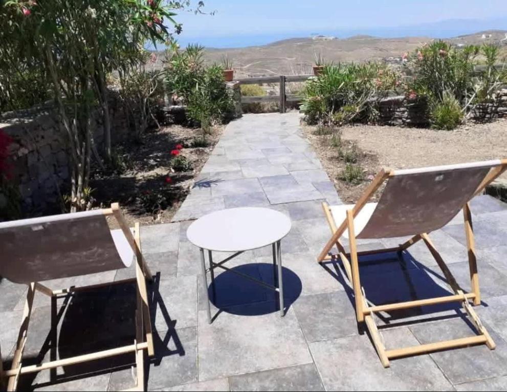 a patio with two chairs and a table at Kea's Hidden Diamond in Otziás