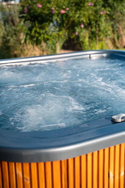 a hot tub with water on top of it at Wellness Hostel Polskie Wrota in Lewin Kłodzki