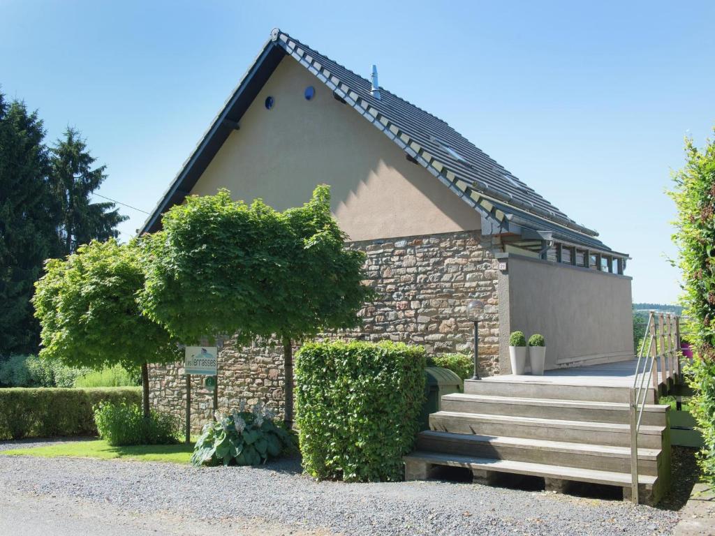 a small house with a staircase in front of it at Cottage in the heart of the Ardennes in Waimes