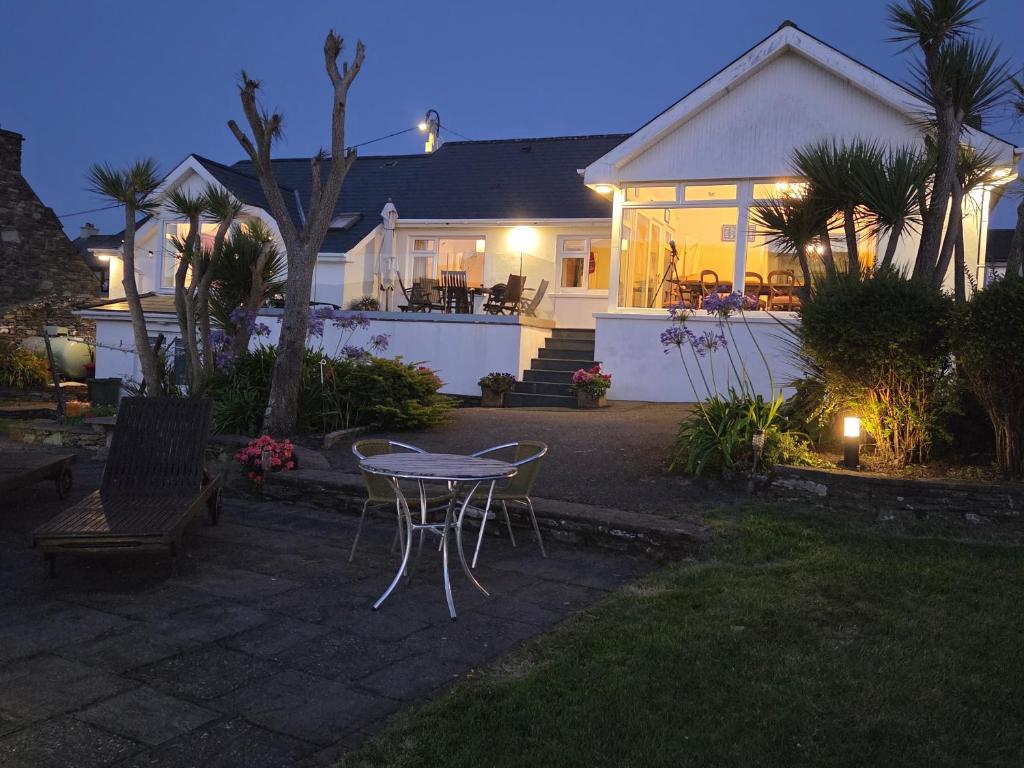 a house with a table and chairs in the yard at Anchor Haven in Goleen