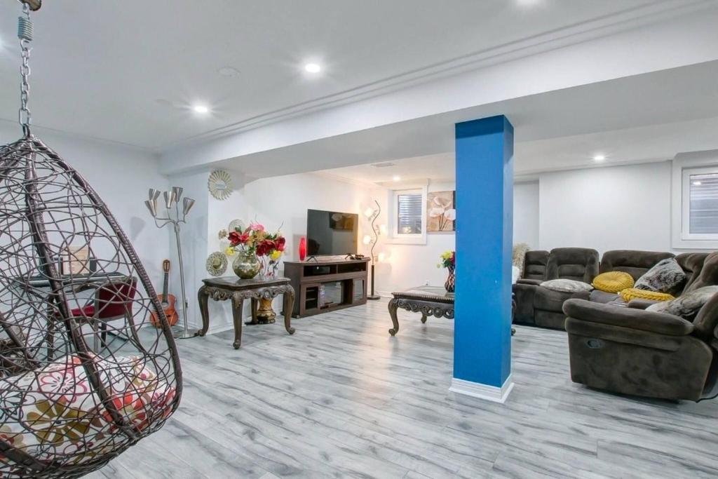 a living room with a couch and a table at A very peaceful home in Oshawa