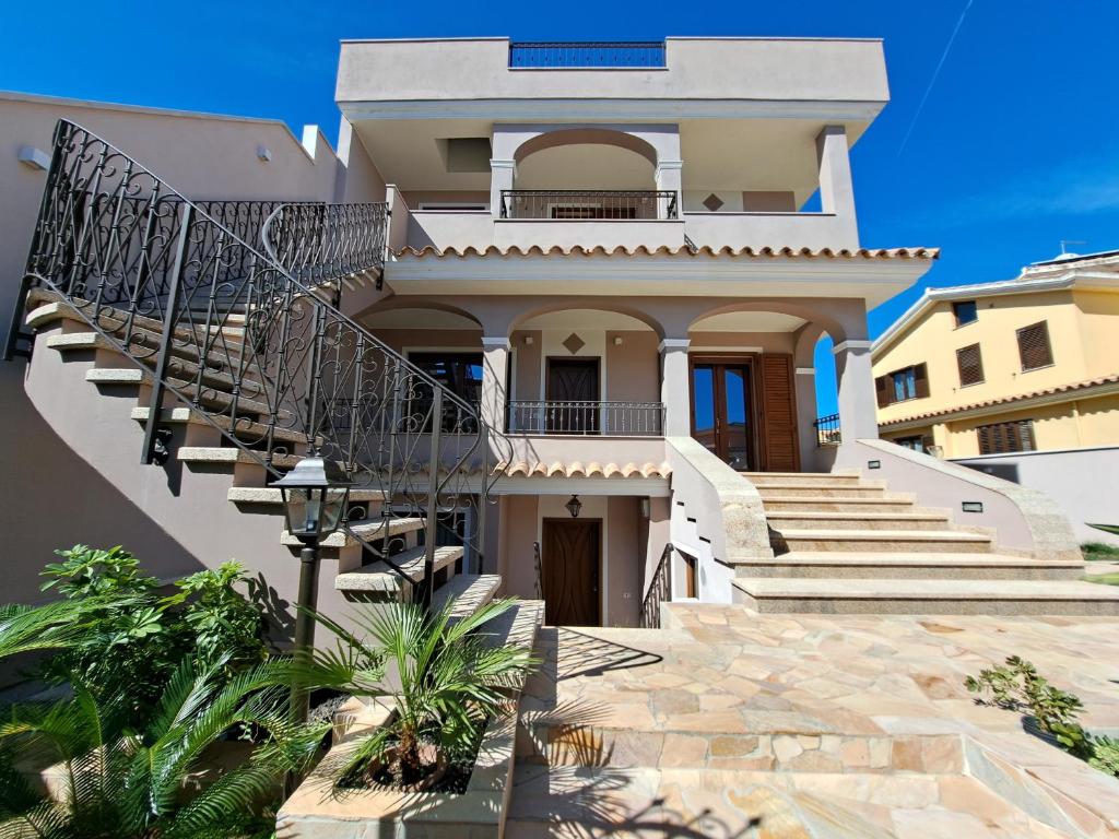 a house with a staircase in front of it at Domu Jole B&B in Selargius