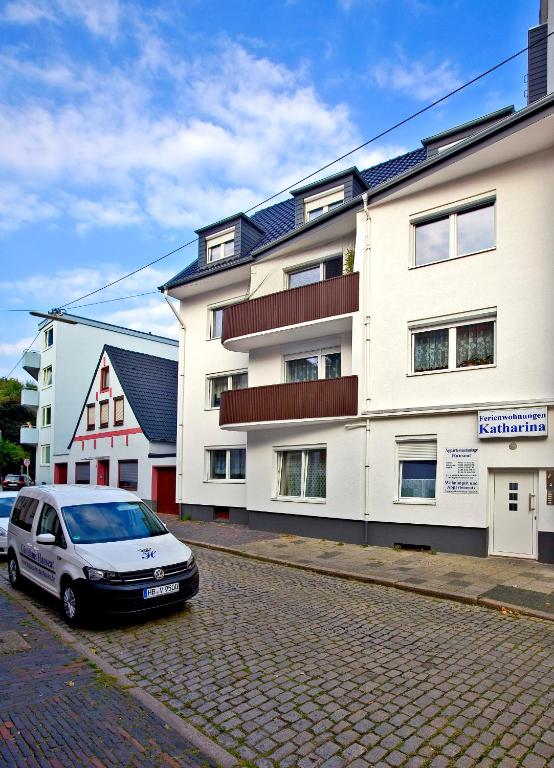 a white car parked in front of a building at FeWo`s Katharina in Bremerhaven