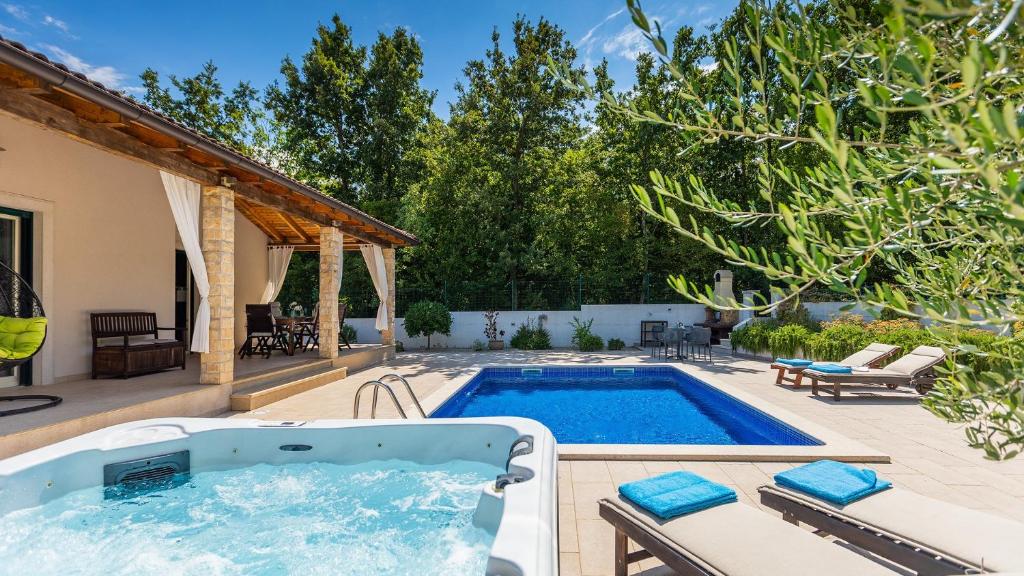 a swimming pool in the backyard of a house at Vila LeDa by Villas Guide in Barban