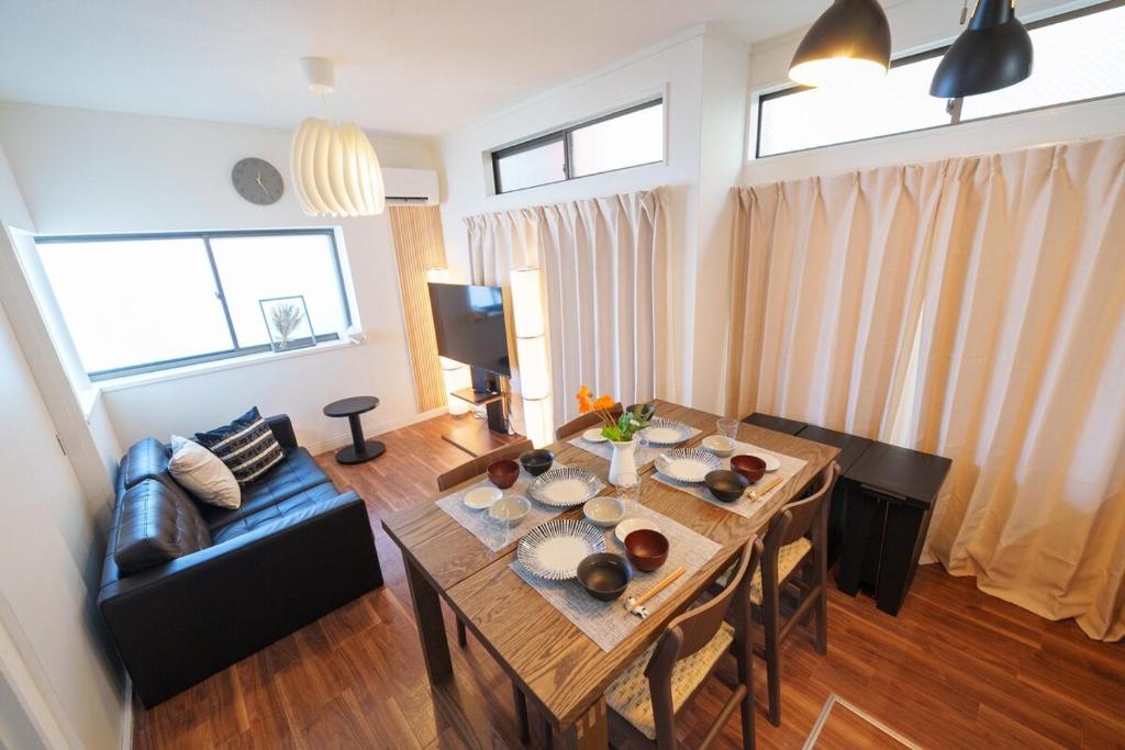 a living room with a table and a couch at Tachikawa City 3LDK Private House in Tachikawa