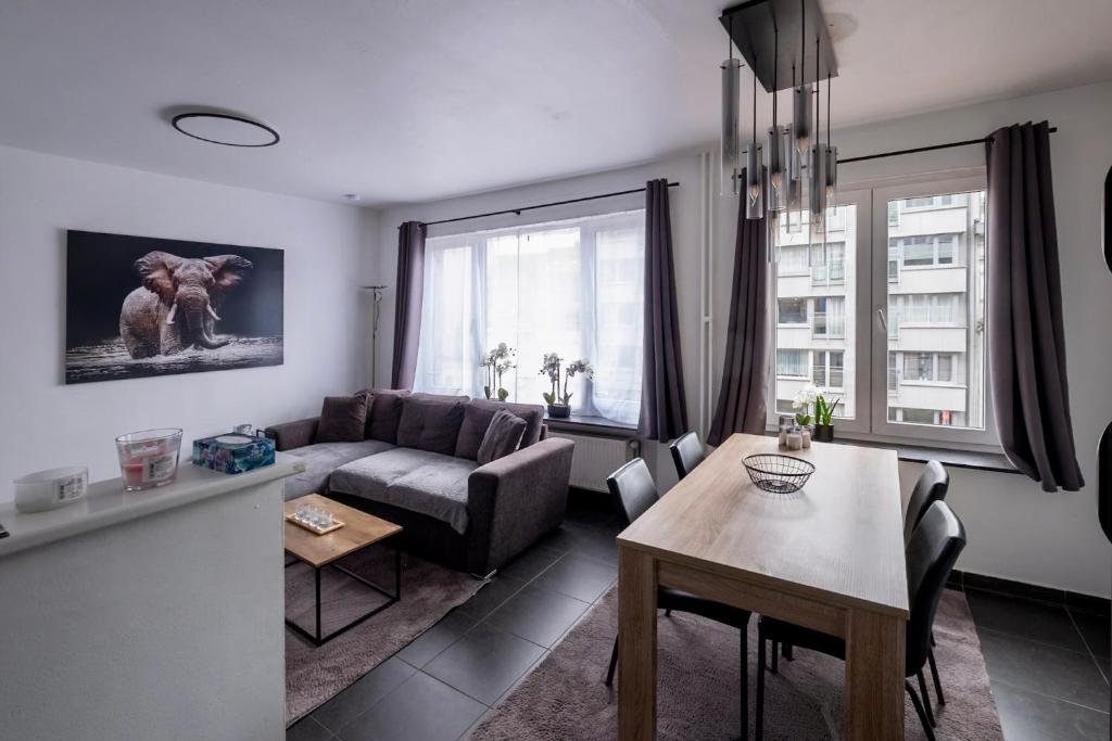 a living room with a couch and a table at Appartement Guillaume in Blankenberge