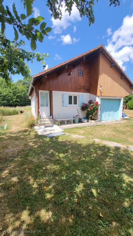 a house with a large yard in front of it at Chalet in Saint-Anthème