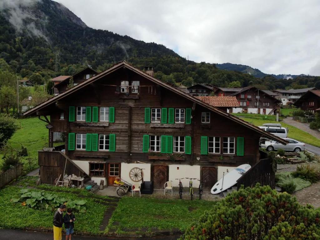 a large wooden house with green shutters at Lake view Chalet , Drligen in Därligen