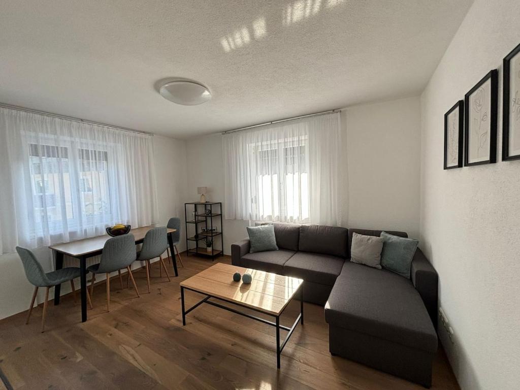 a living room with a couch and a table at Gemütliche Wohnung in Puch in Puch bei Hallein