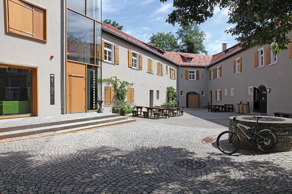 a bike parked in the courtyard of a building at Jugendherberge Ravensburg in Ravensburg