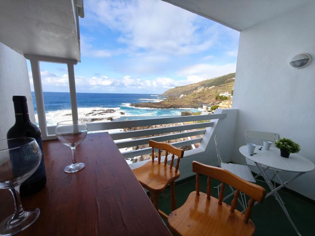 a balcony with a table and a view of the ocean at Sunset living area in Puerto de la Madera