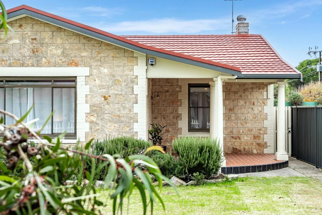 a brick house with a red roof at The Wharf House Goolwa in Goolwa