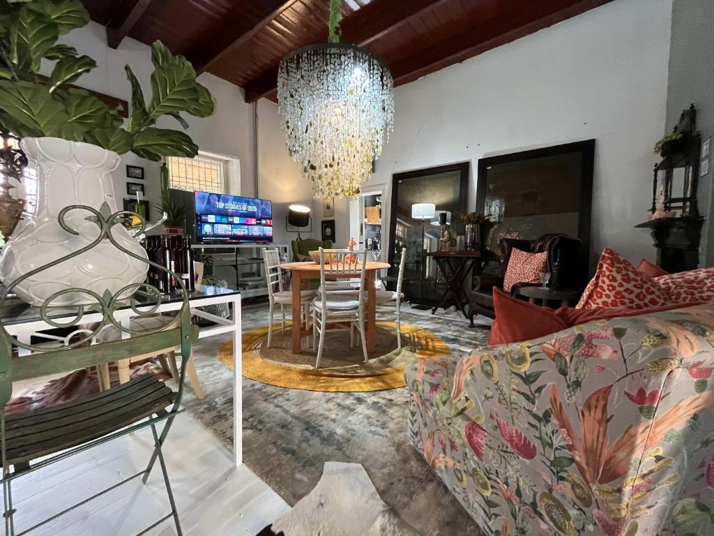 a living room with a couch and a table at Calitzdorp Self-Catering Guesthouse - Oudehuis in Calitzdorp