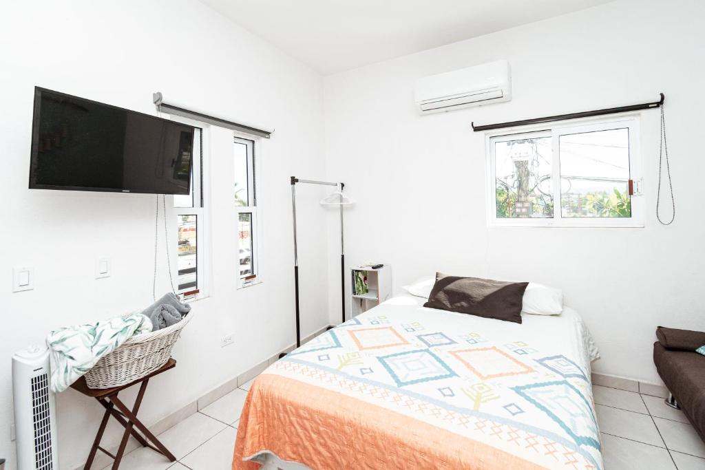 a bedroom with a bed and a flat screen tv at Departamento Palmita in La Paz