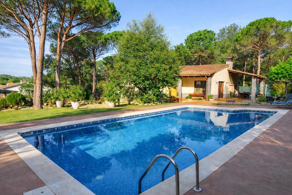 a swimming pool in front of a house at Spacious Countryside Costa Brava Relax in Sils